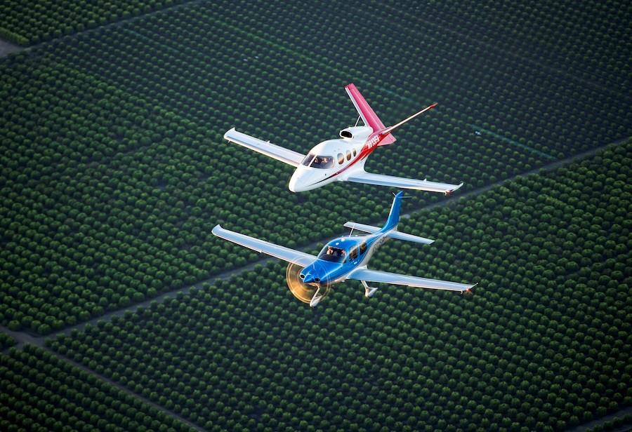 Two airplanes flying over field